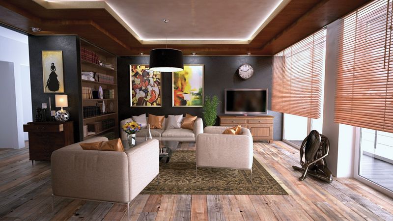 Open-plan living room with cream sofas, patterned rug and wooden floor